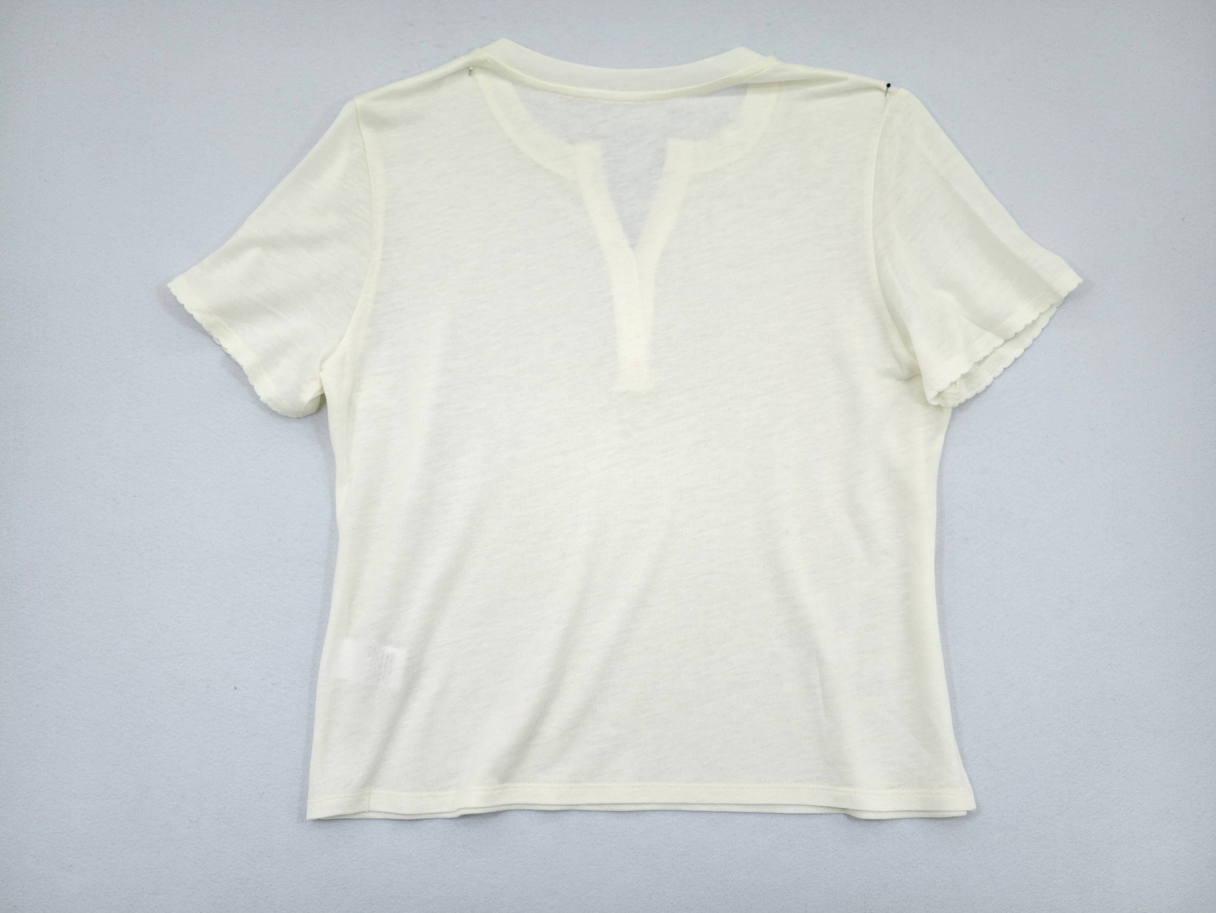 Back view of women's Henley knit top from clothing supplier