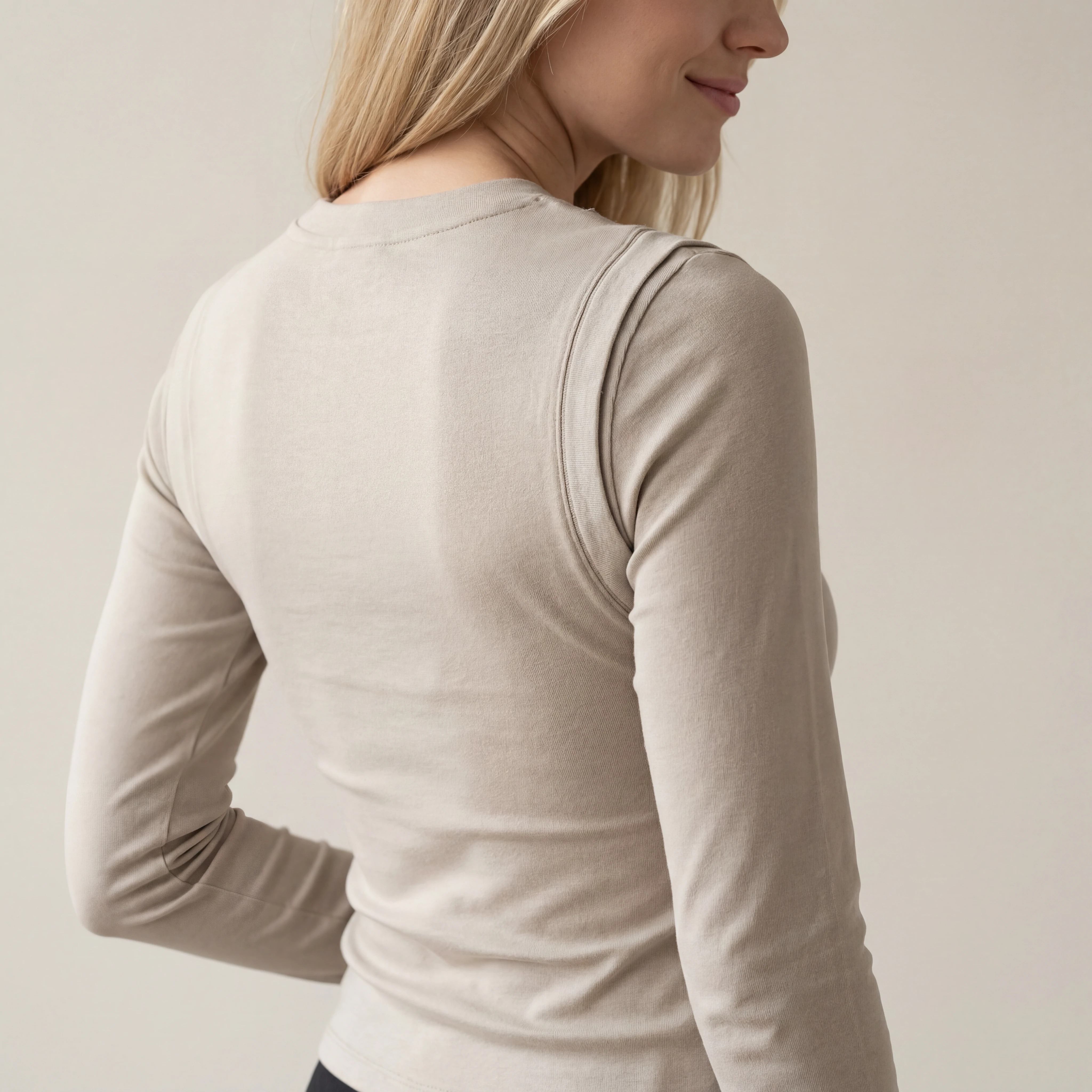 Back view of fitted long-sleeve shoulder cutout top