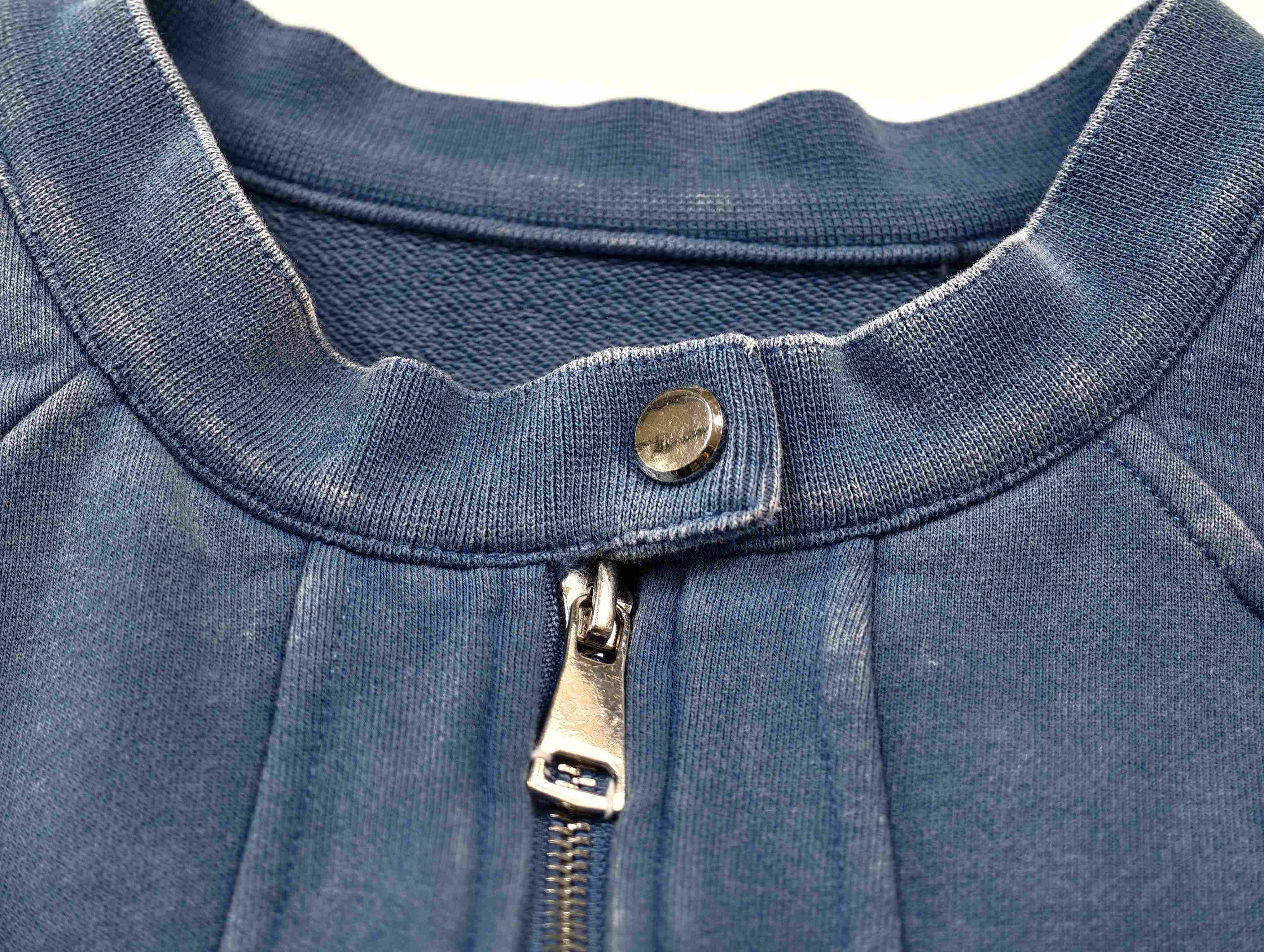 Snap-tab collar and metal zipper construction close-up