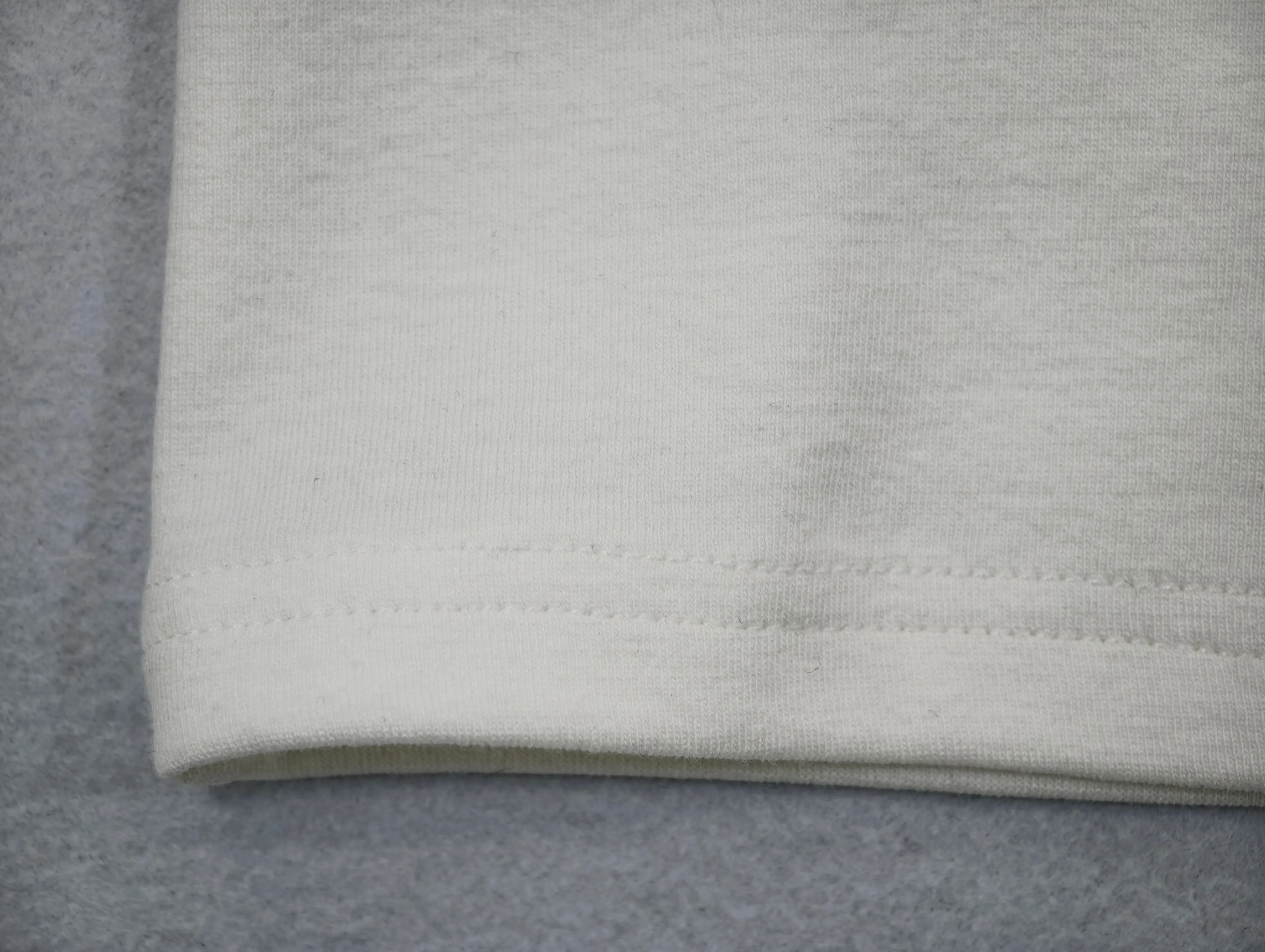 Fine 1×1 rib texture with twin-needle hem