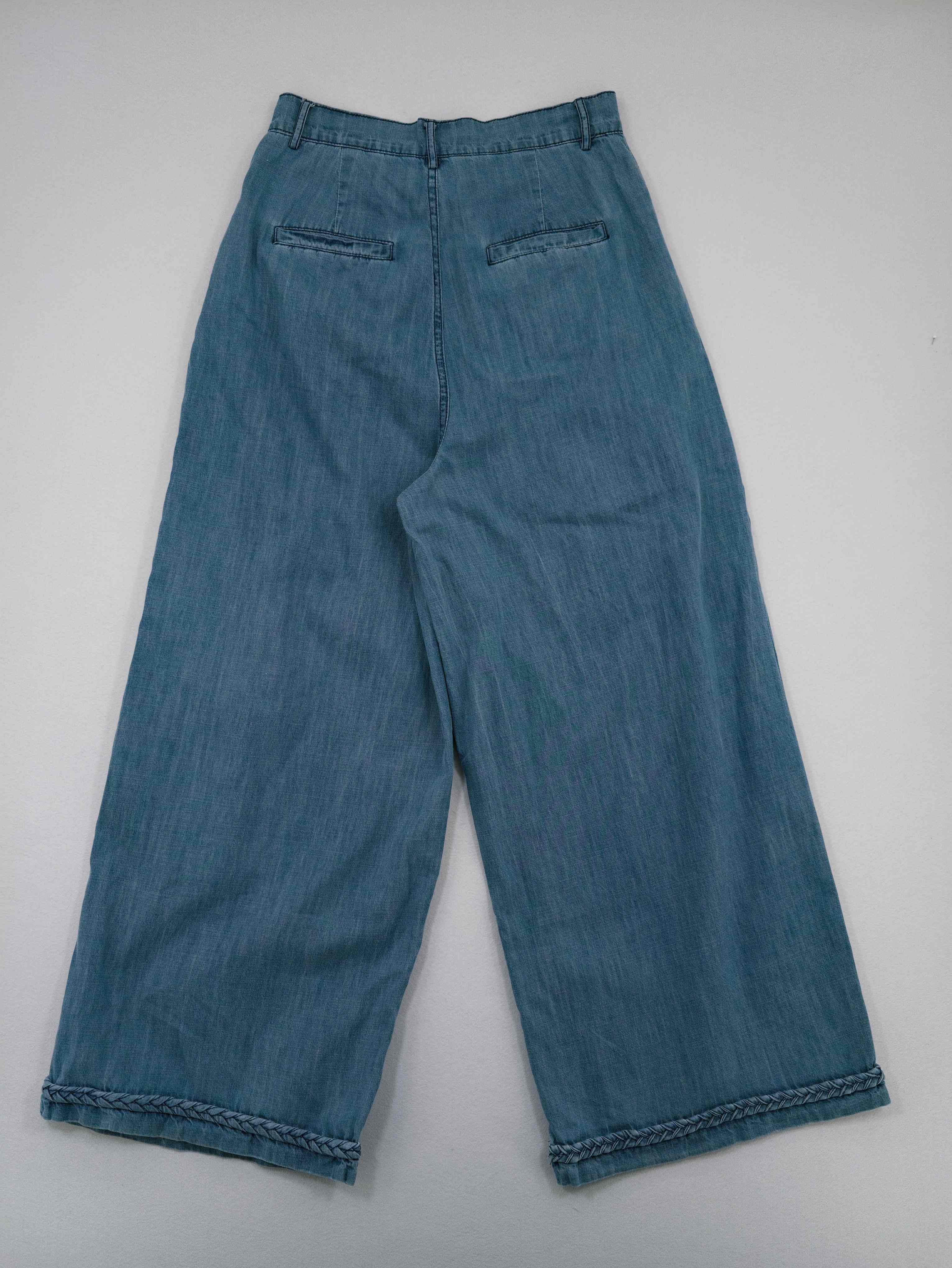 Back view with welt pockets and full-length wide legs