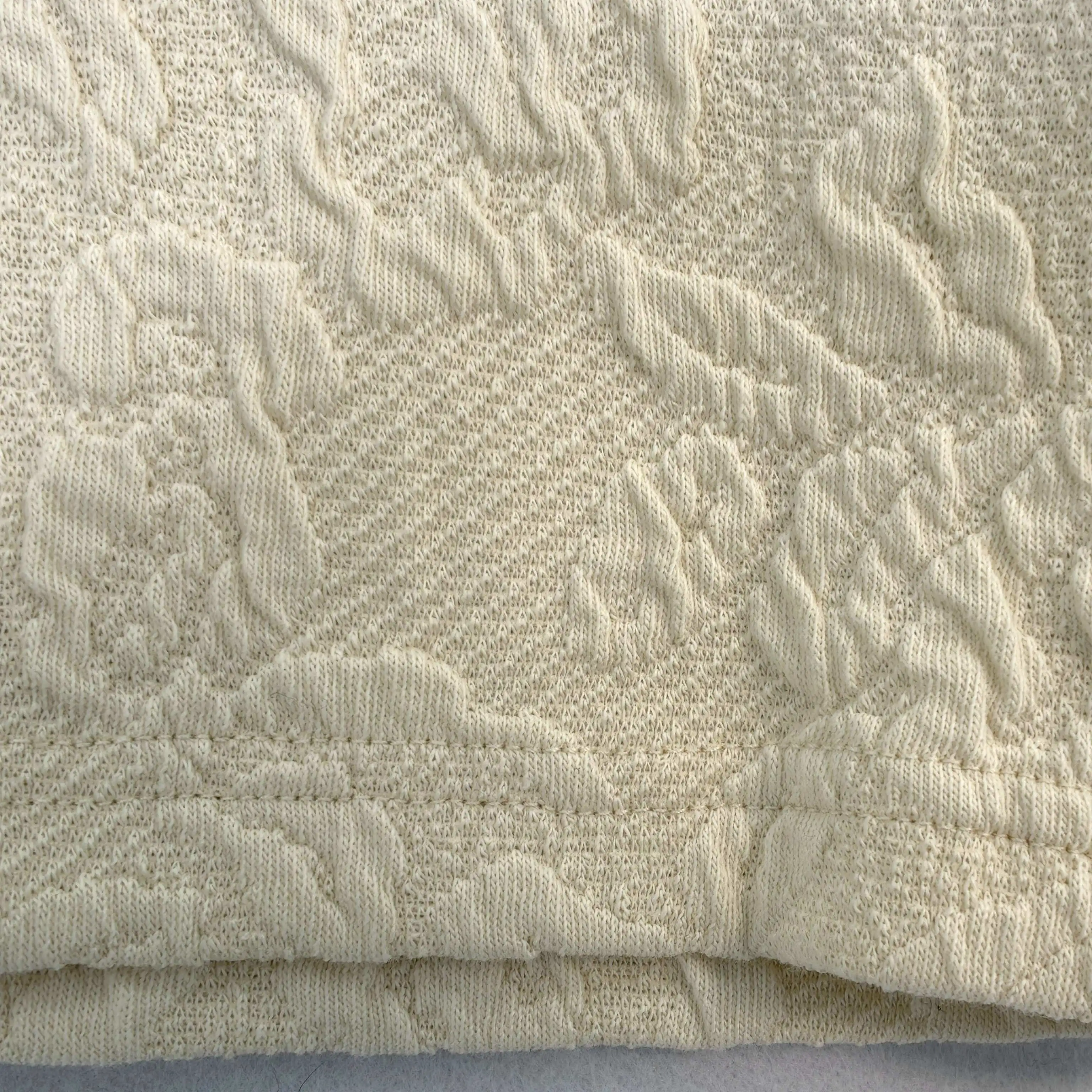 Raised floral jacquard texture with clean double-needle hem