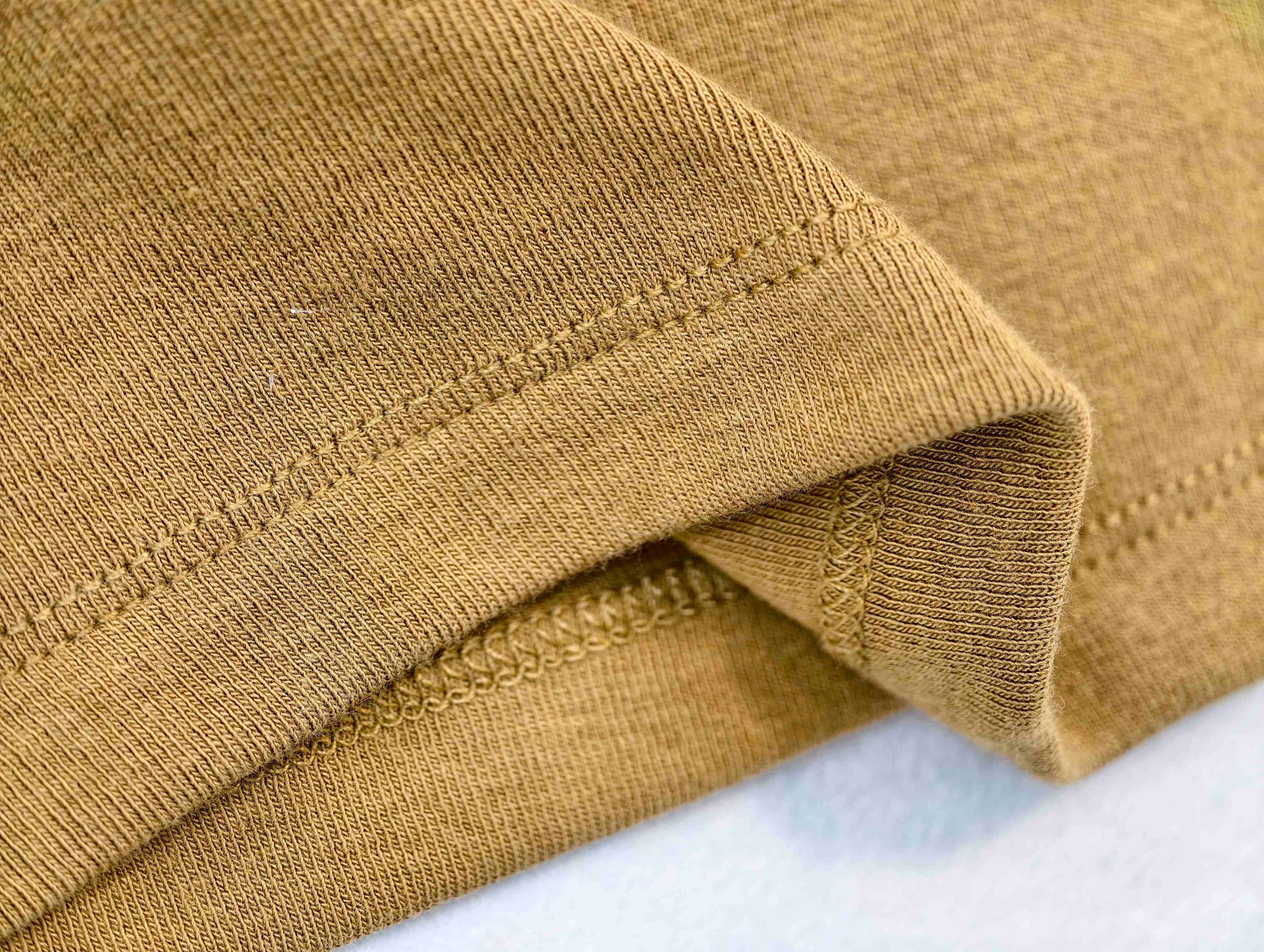 Stretch-knit fabric with clean double-stitched hem detail