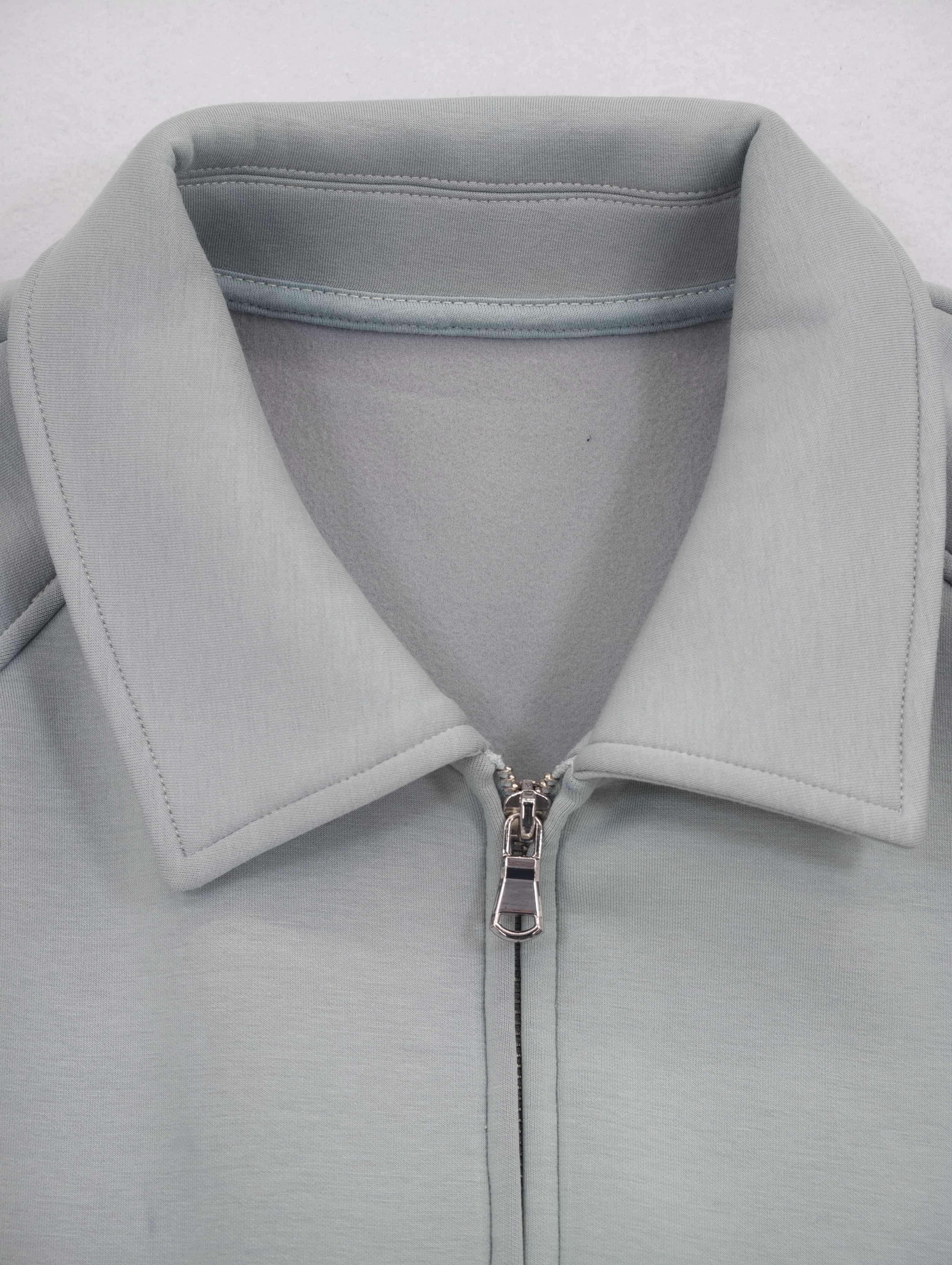 Point collar and front metal zipper construction detail