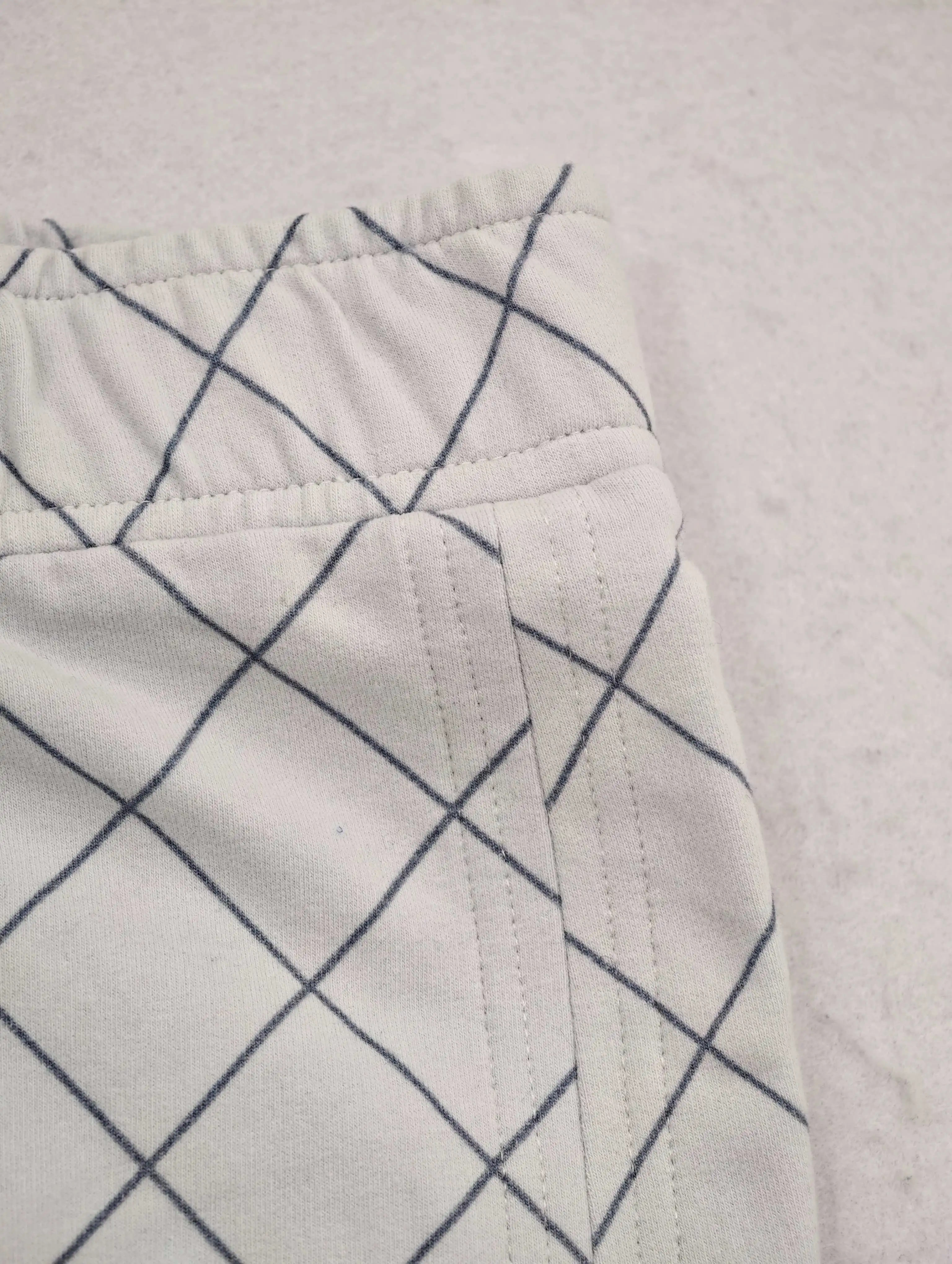 Elastic waistband and angled side pocket construction