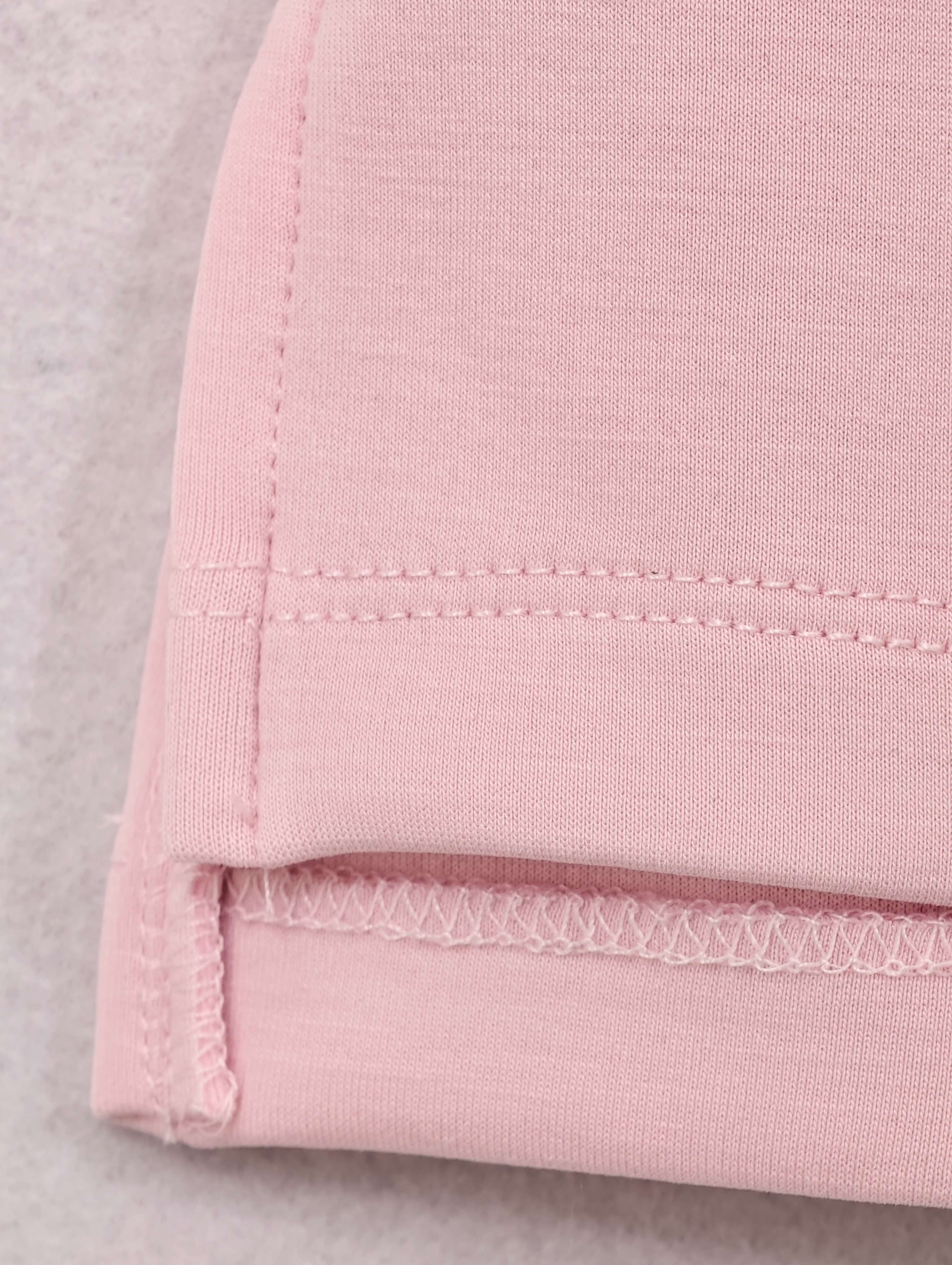 Sleeveless armhole and hem stitching detail in blush knit