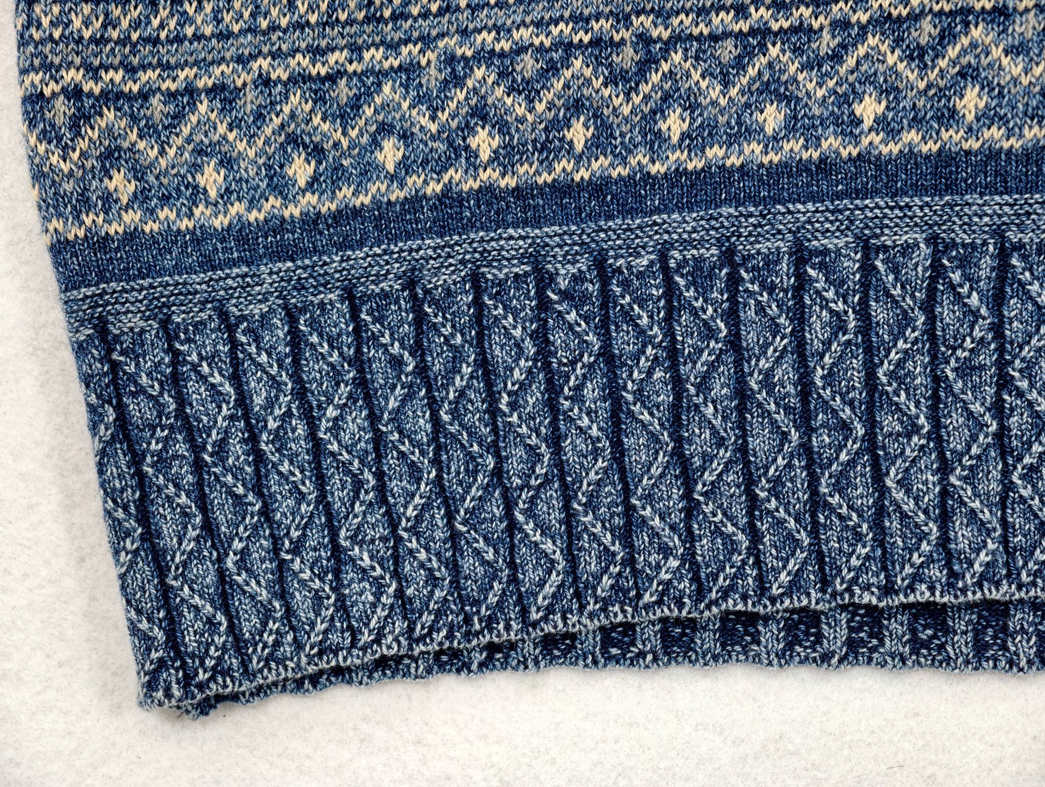 Cable-knit ribbed hem beneath geometric jacquard bands