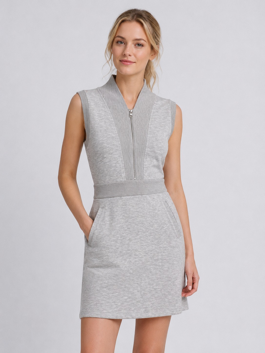 Model wearing grey sleeveless half-zip mini dress