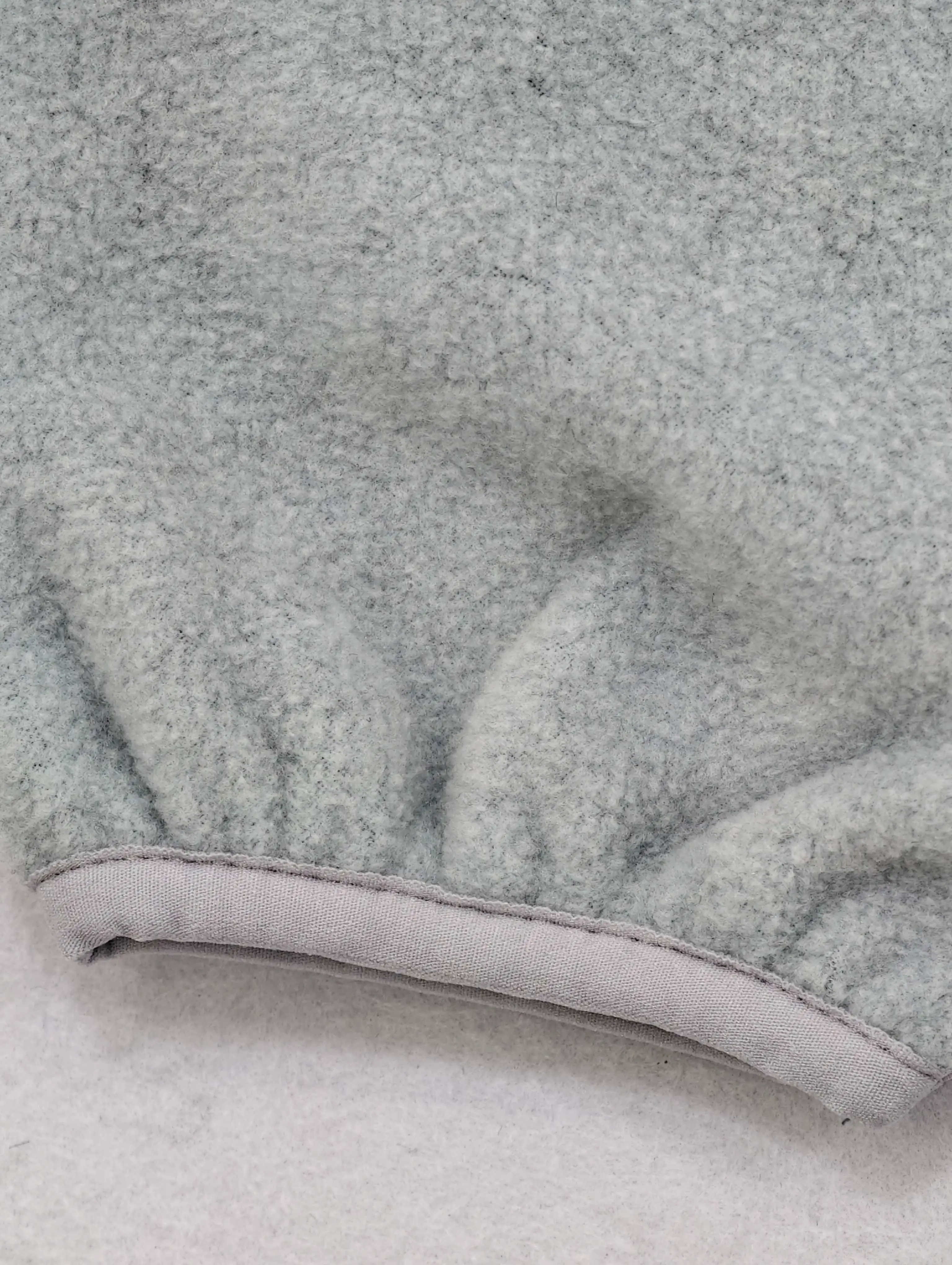 Curved fleece edge with contrast binding finish