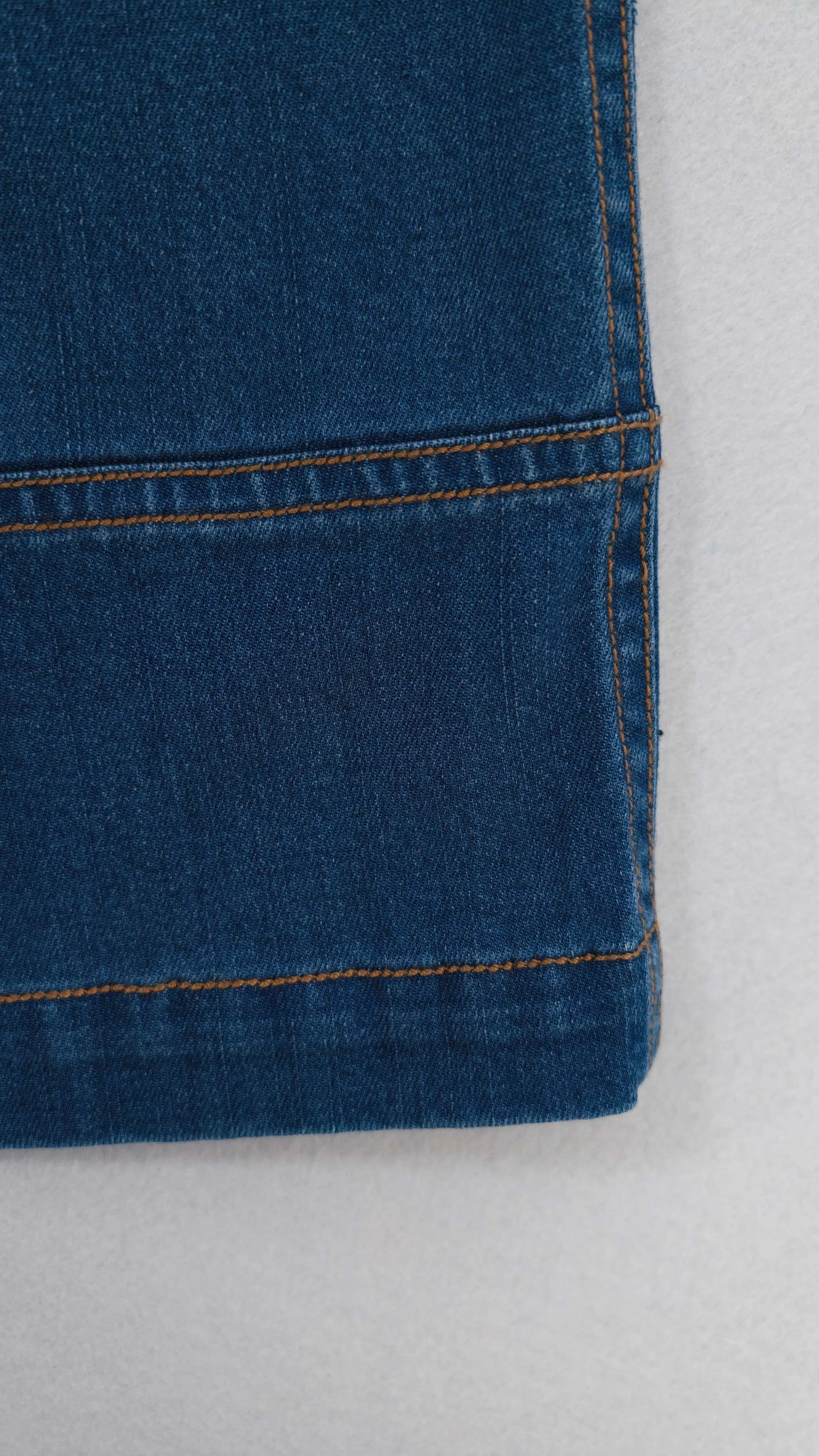 Cropped denim hem panel with contrast topstitching