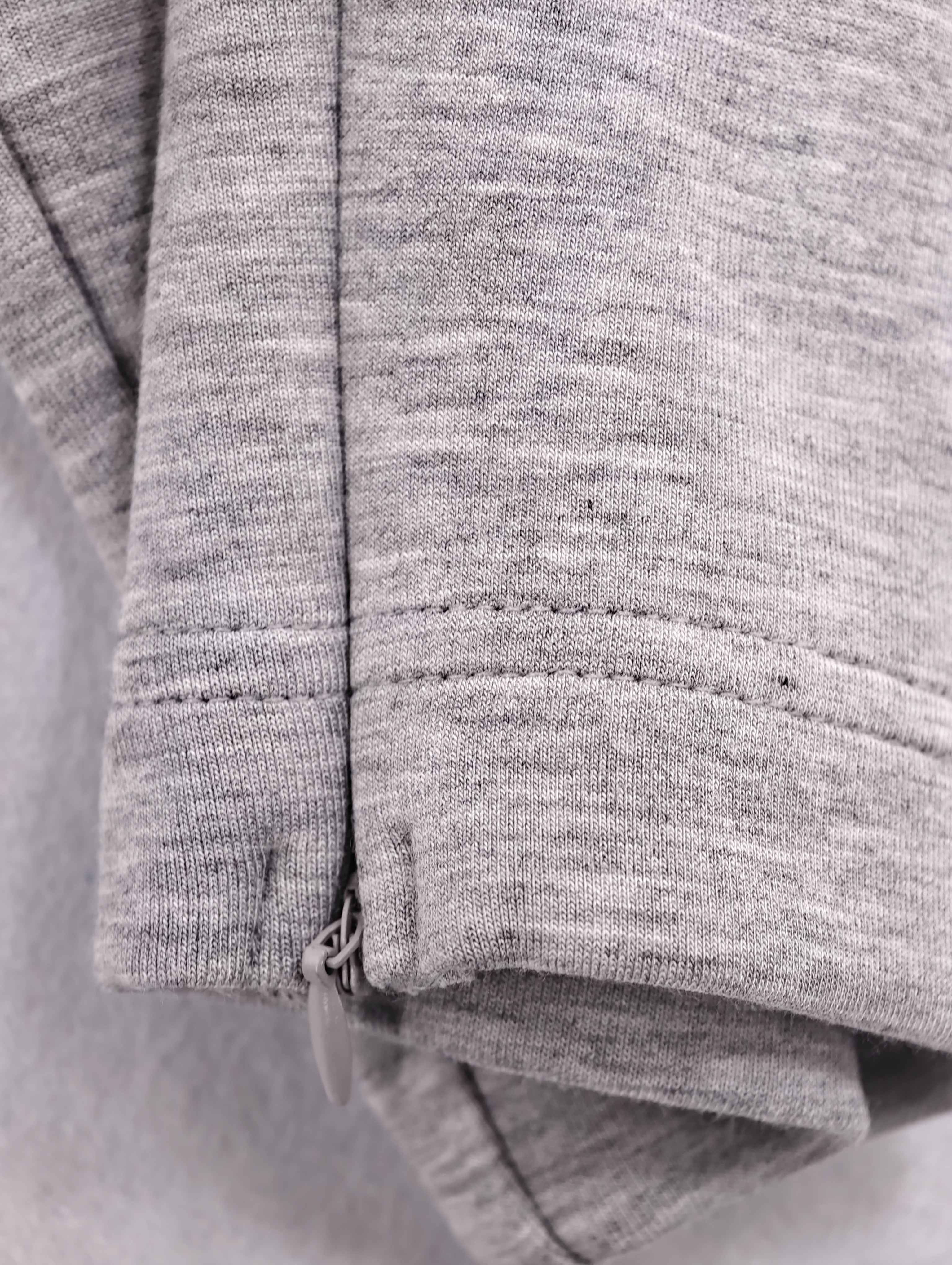 Side seam and ankle hem stitching on grey joggers