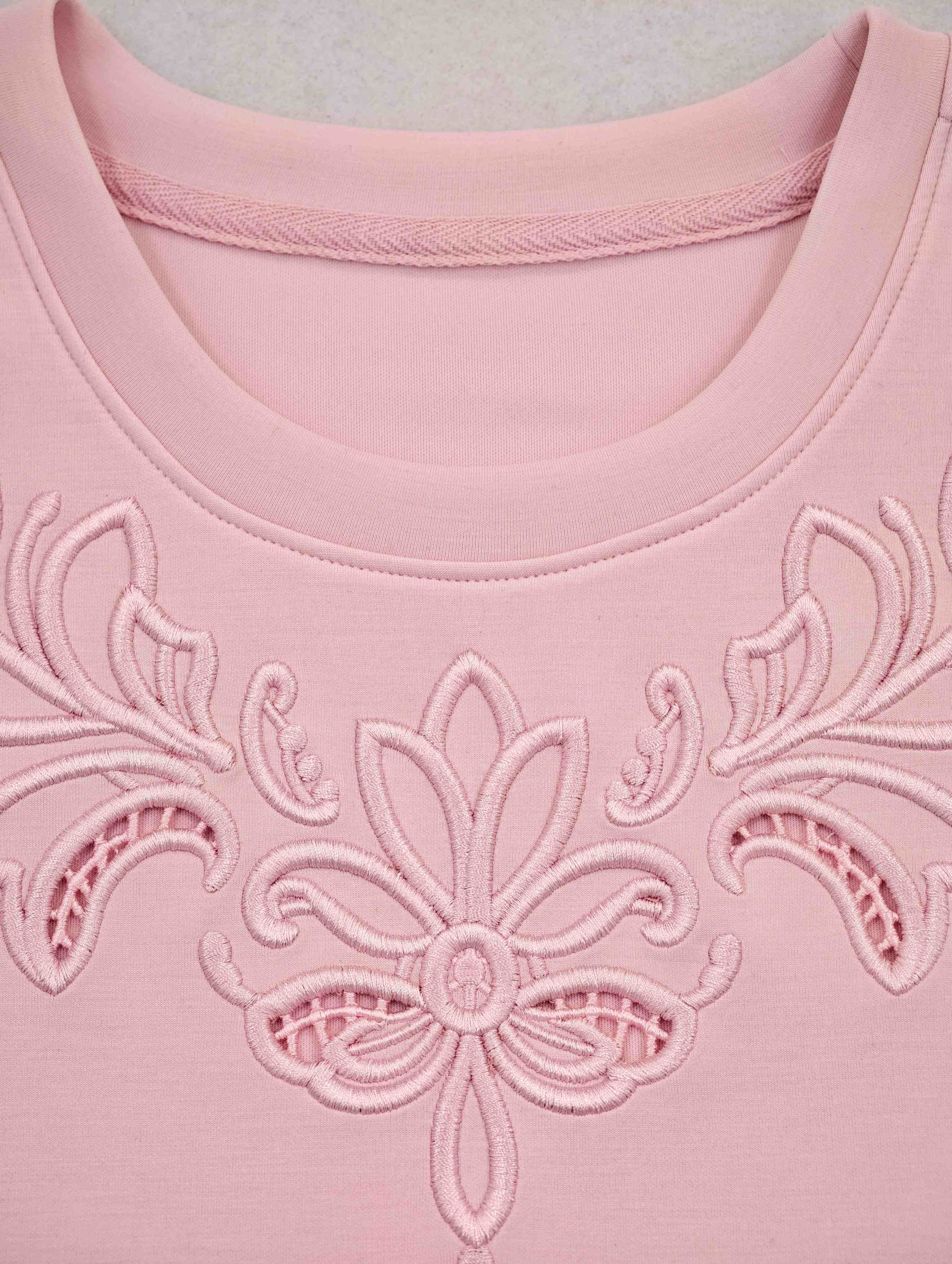 Tonal floral embroidery below ribbed crew neckline