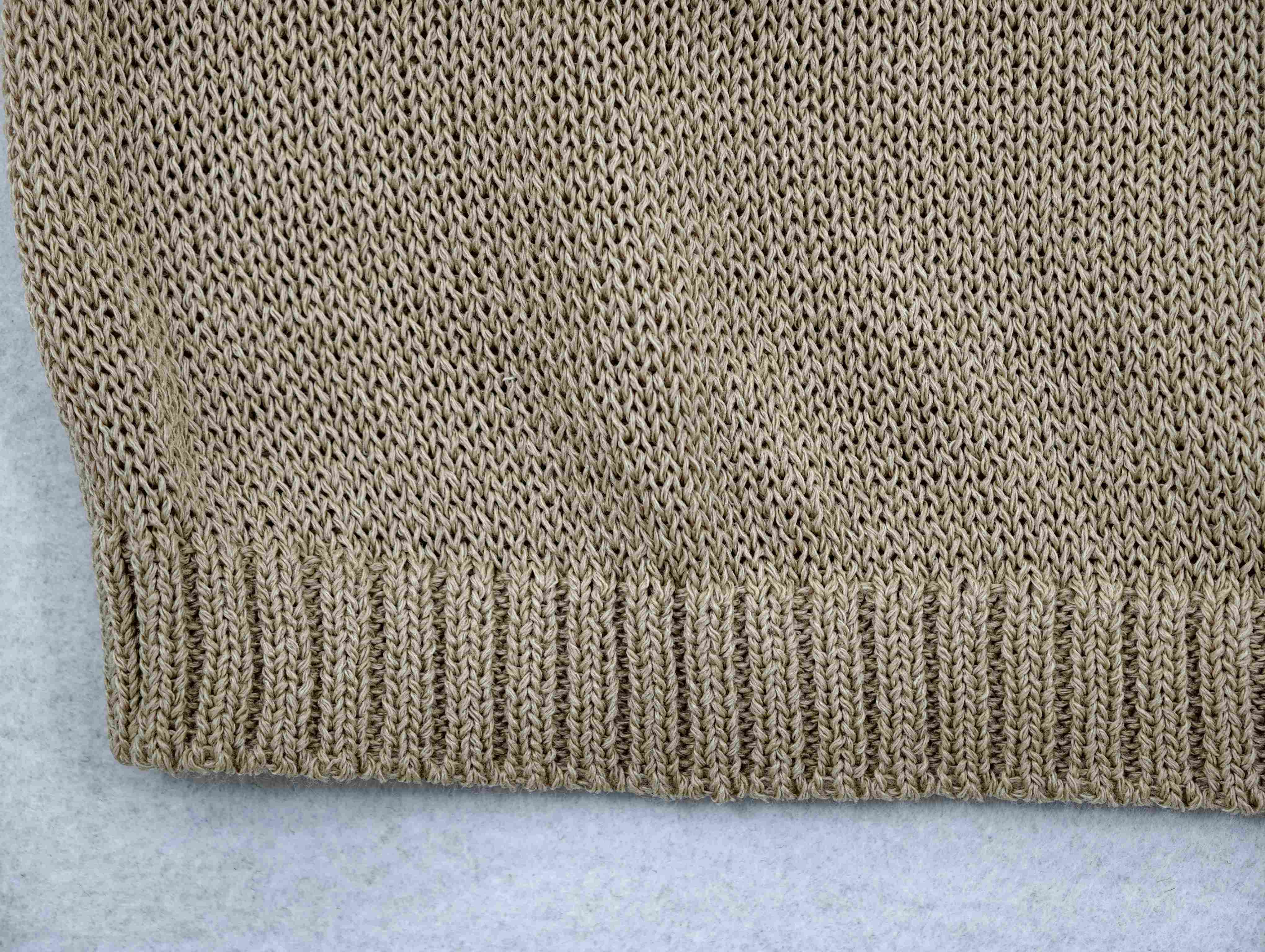 Textured mixed-fiber knit and ribbed hem detail for a custom apparel supplier