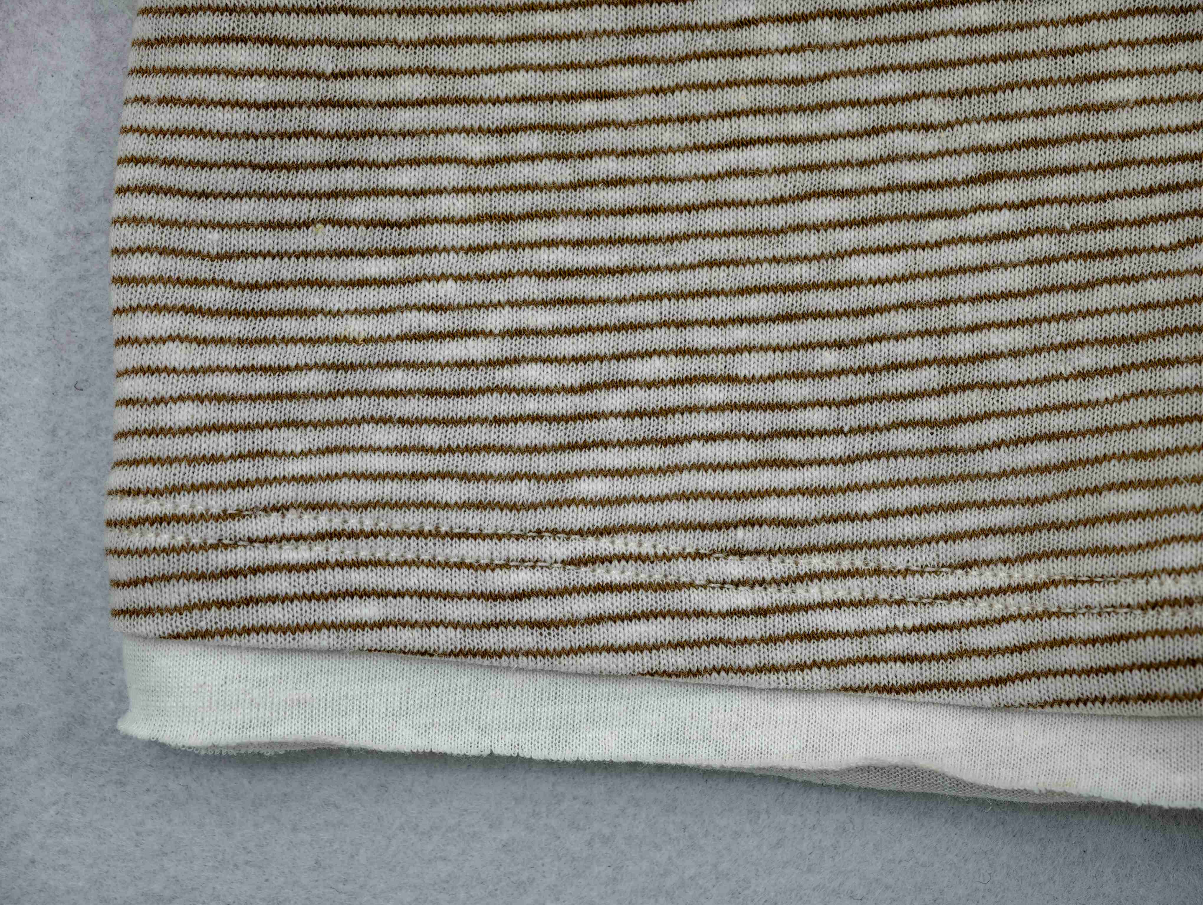 Fine linen-blend stripes above contrast hem layer
