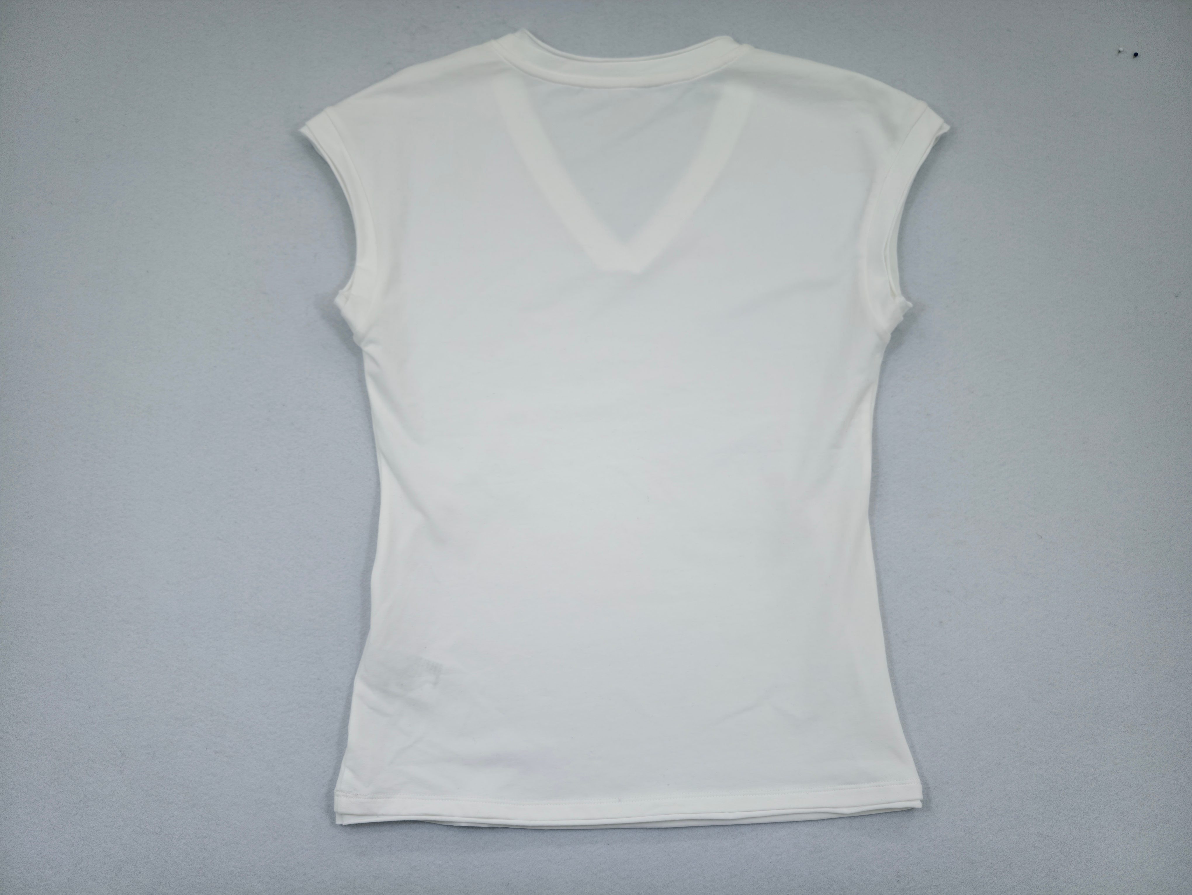 Back view showing extended shoulders and straight silhouette