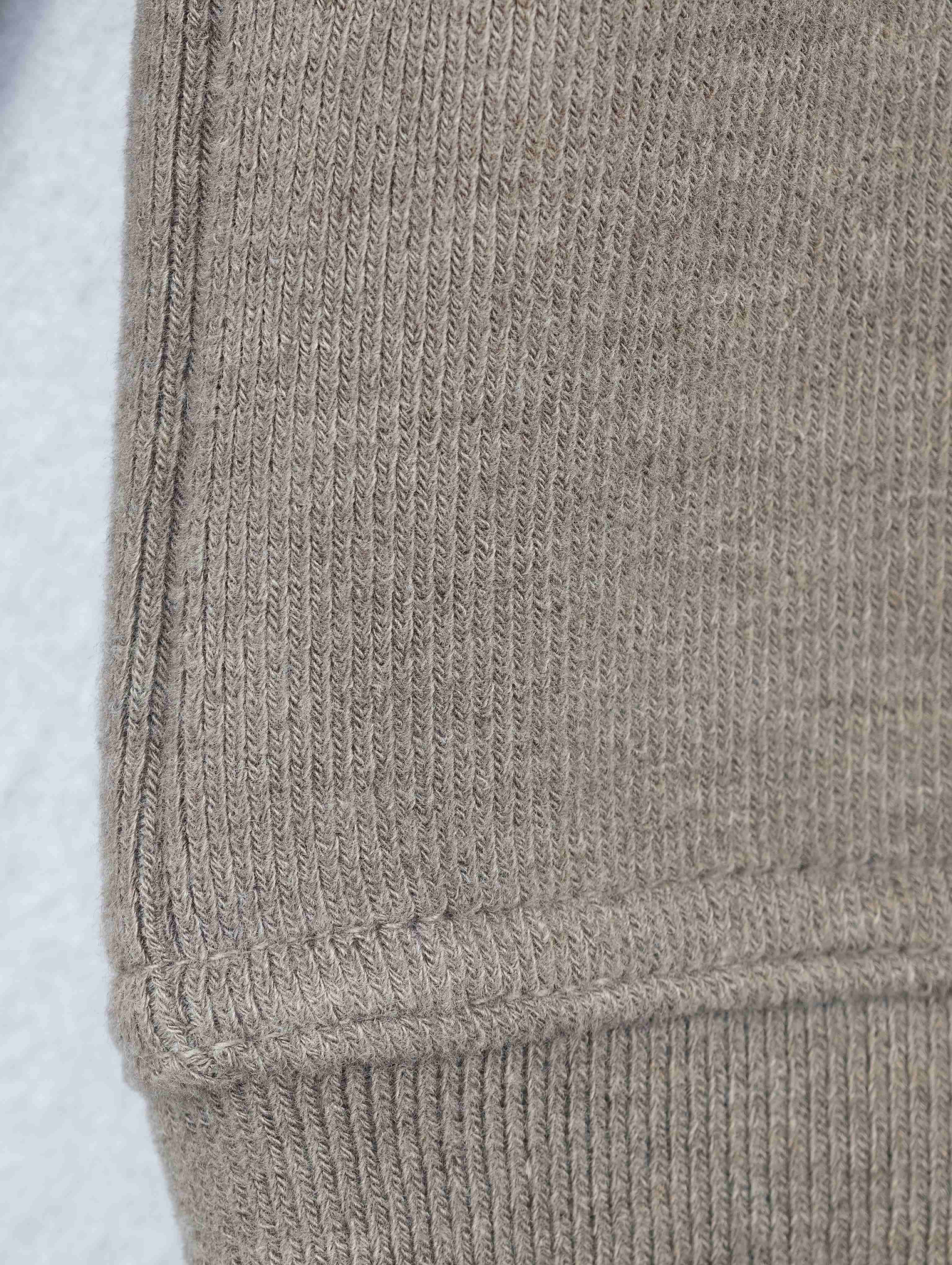 Ribbed cuff with reinforced seam and topstitching detail