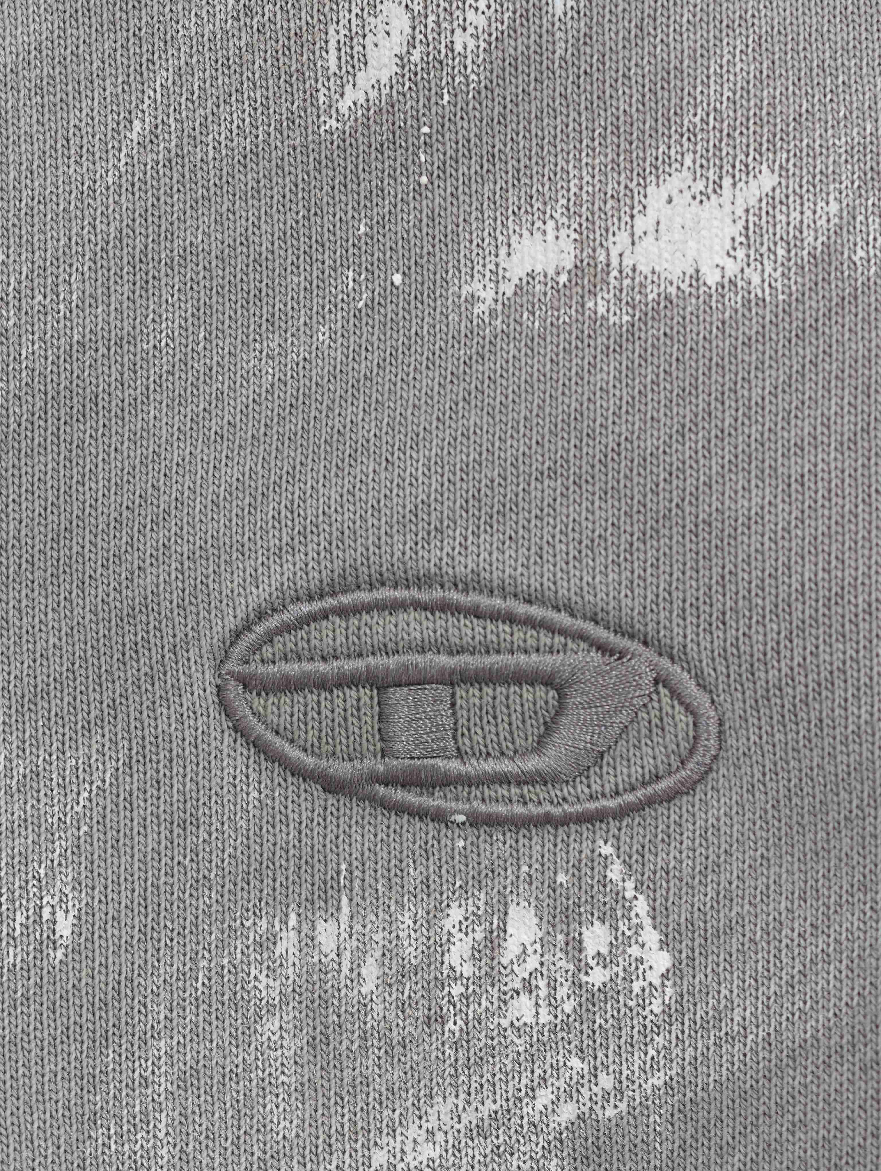 Small tonal chest embroidery on distressed fabric