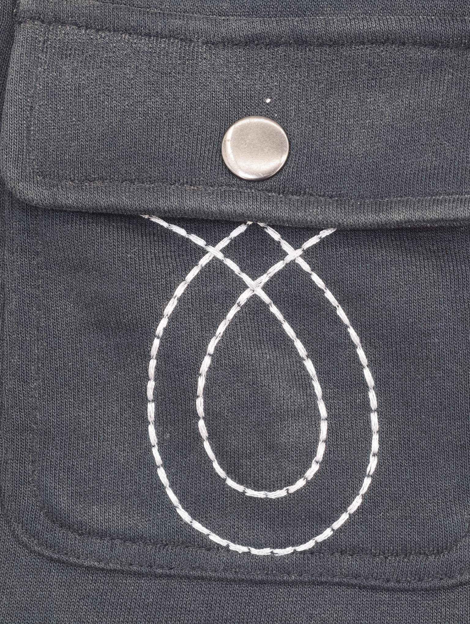 Decorative stitching detail on front pocket panel