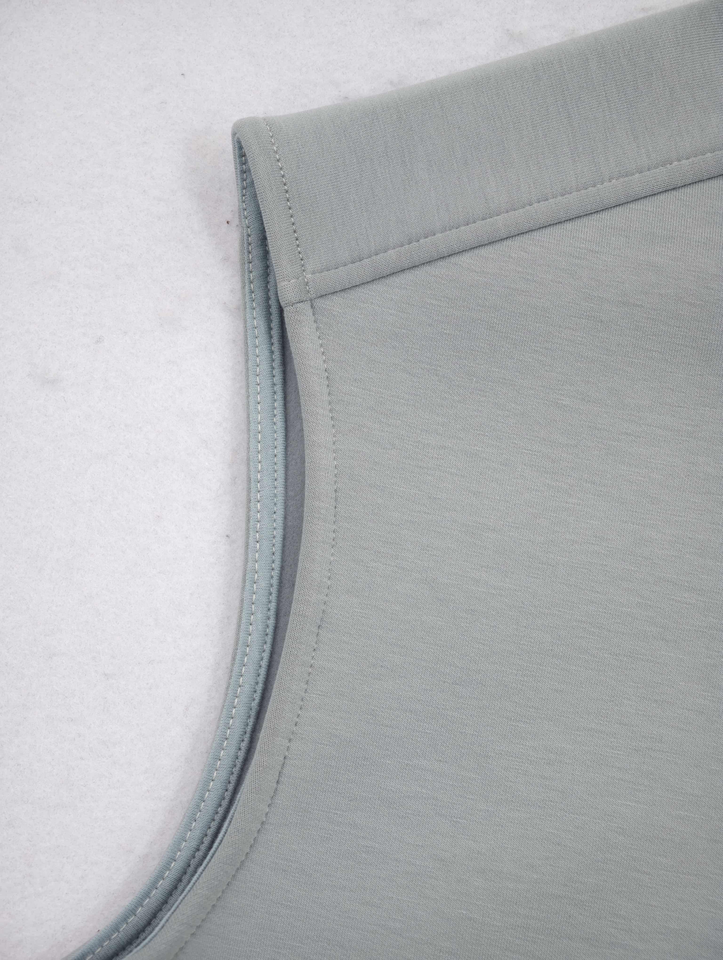 Extended shoulder and clean armhole construction detail