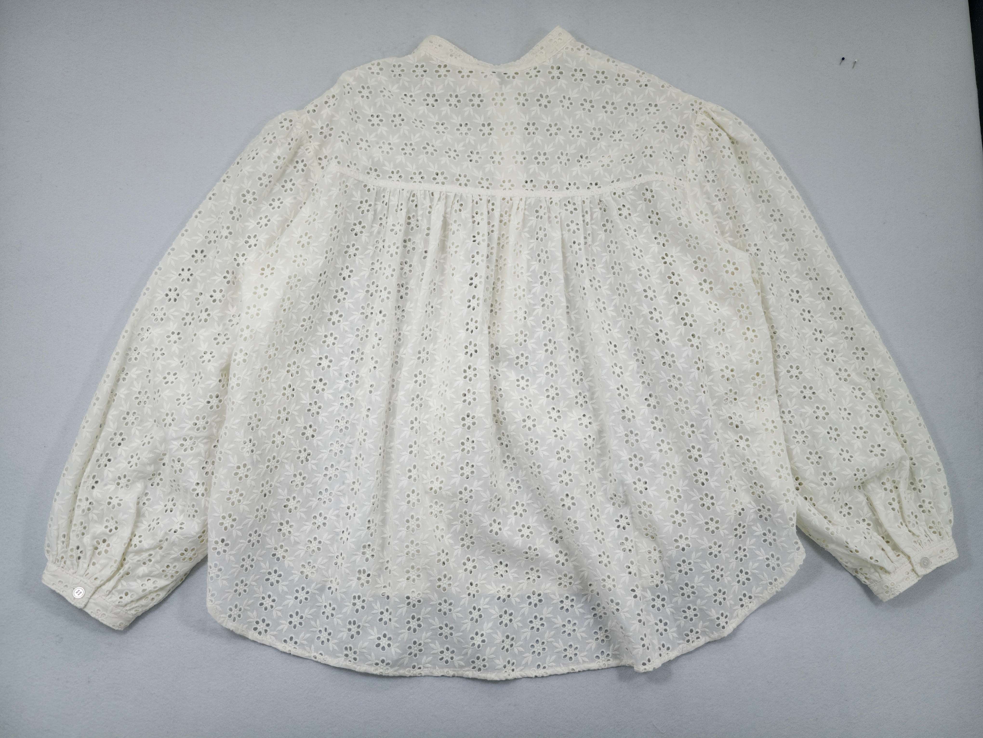 Back flat view showing gathered yoke and curved hem