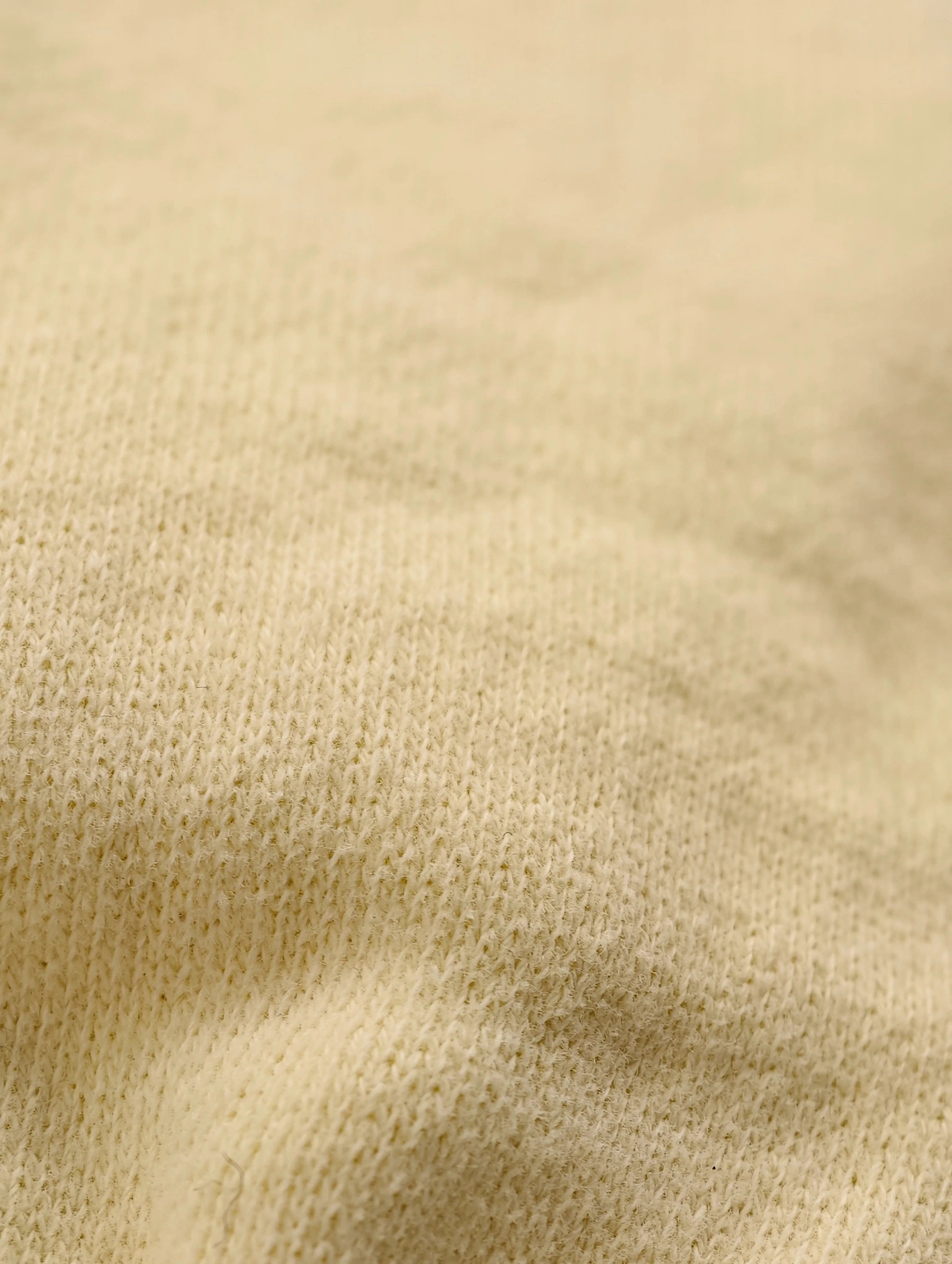 Close-up of butter yellow cotton-polyester sweatshirt knit