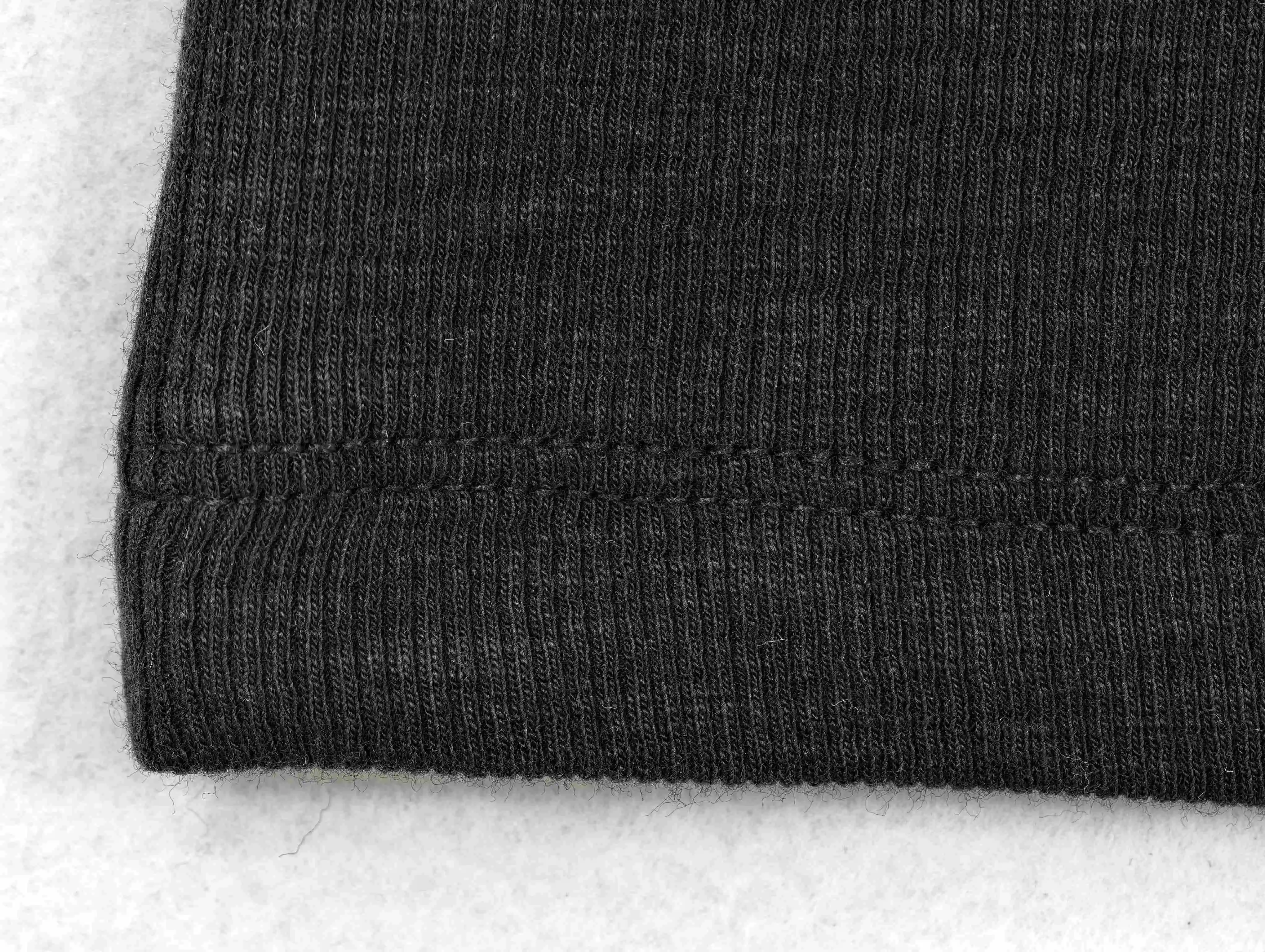 Fine black rib texture with twin-needle hem stitching
