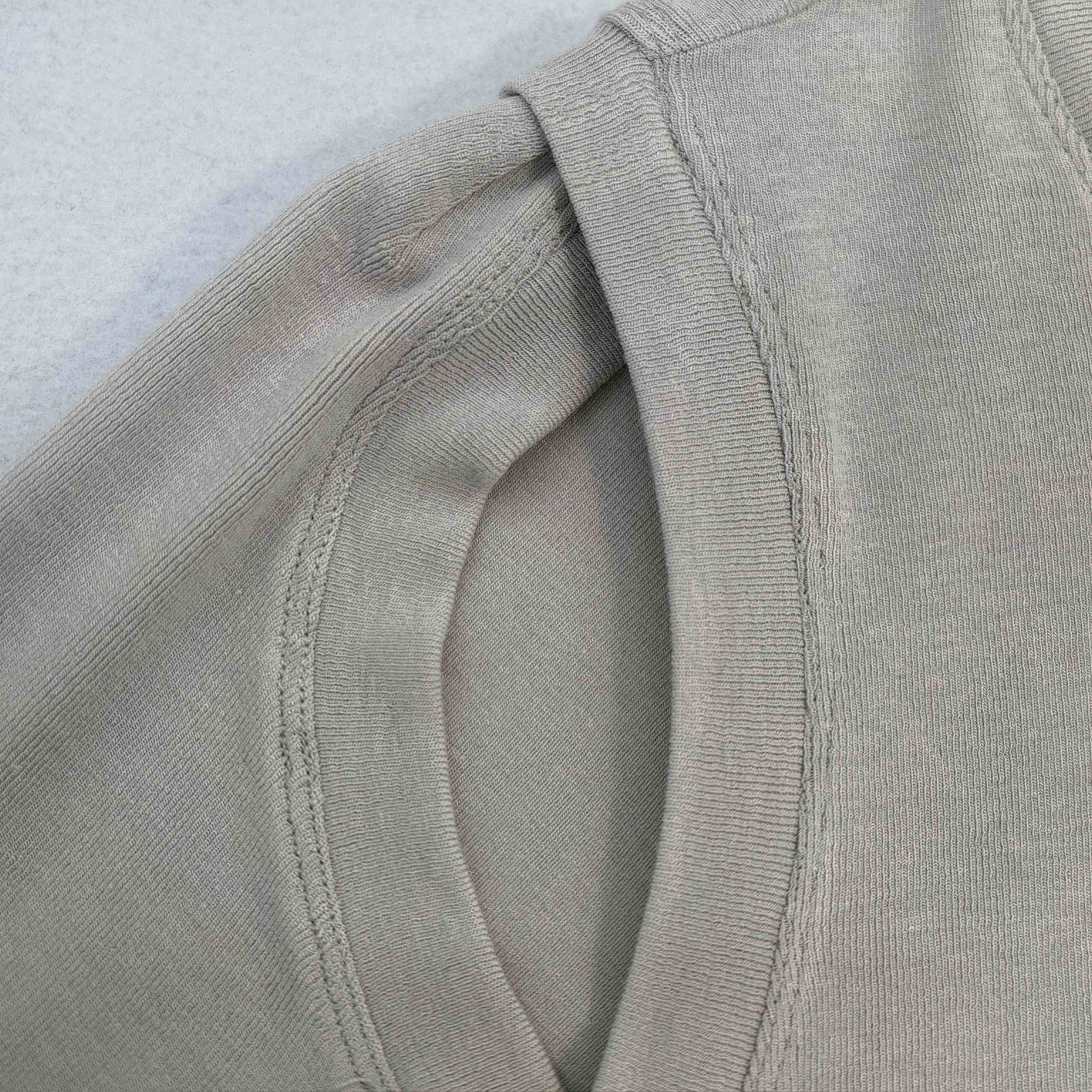 Bound shoulder opening with reinforced sleeve attachment detail
