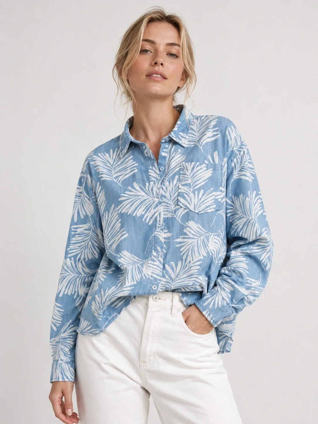 Women wearing blue tropical-print Tencel button-up shirt
