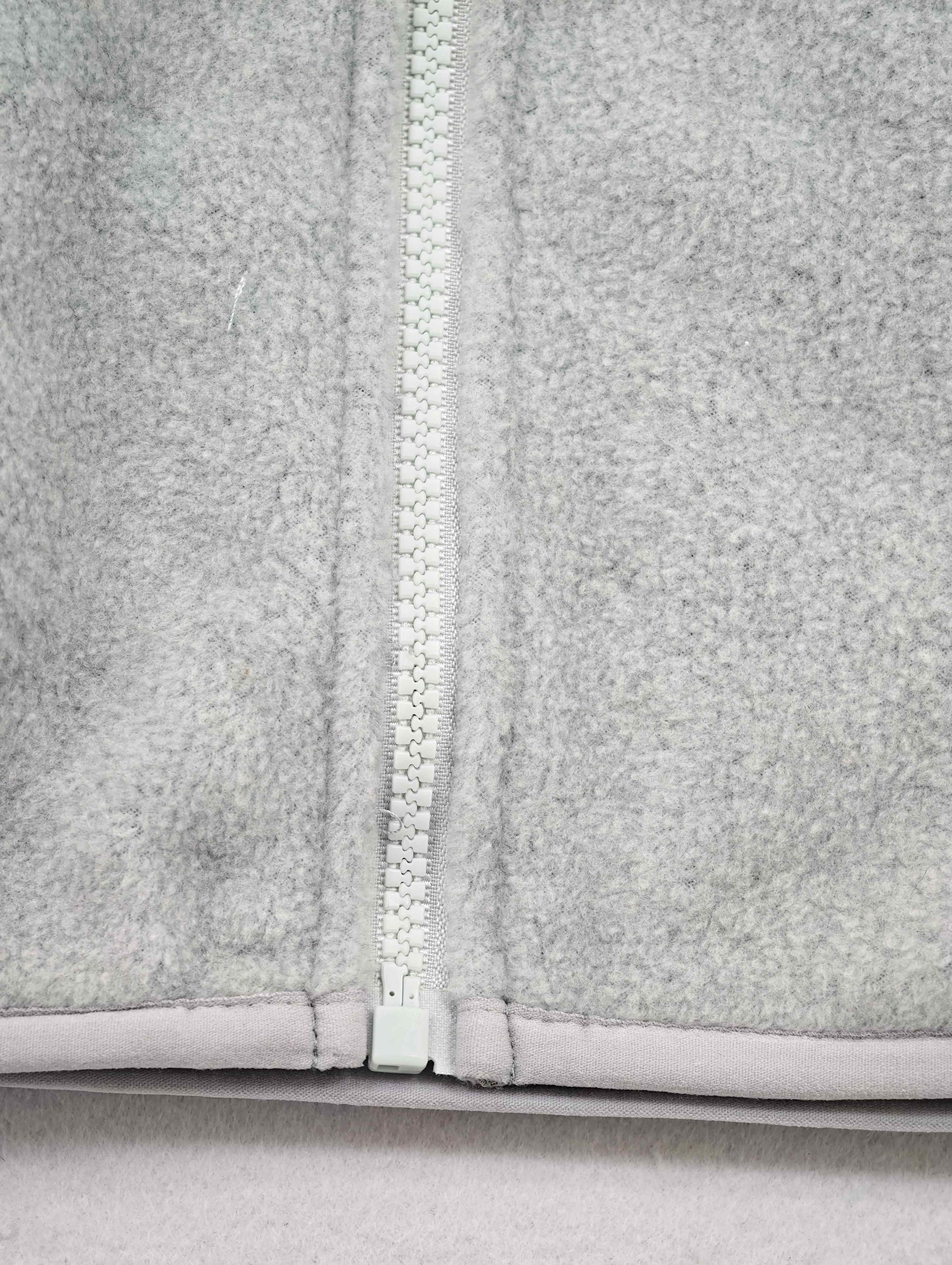 Front zipper and bound hem detail on fleece vest