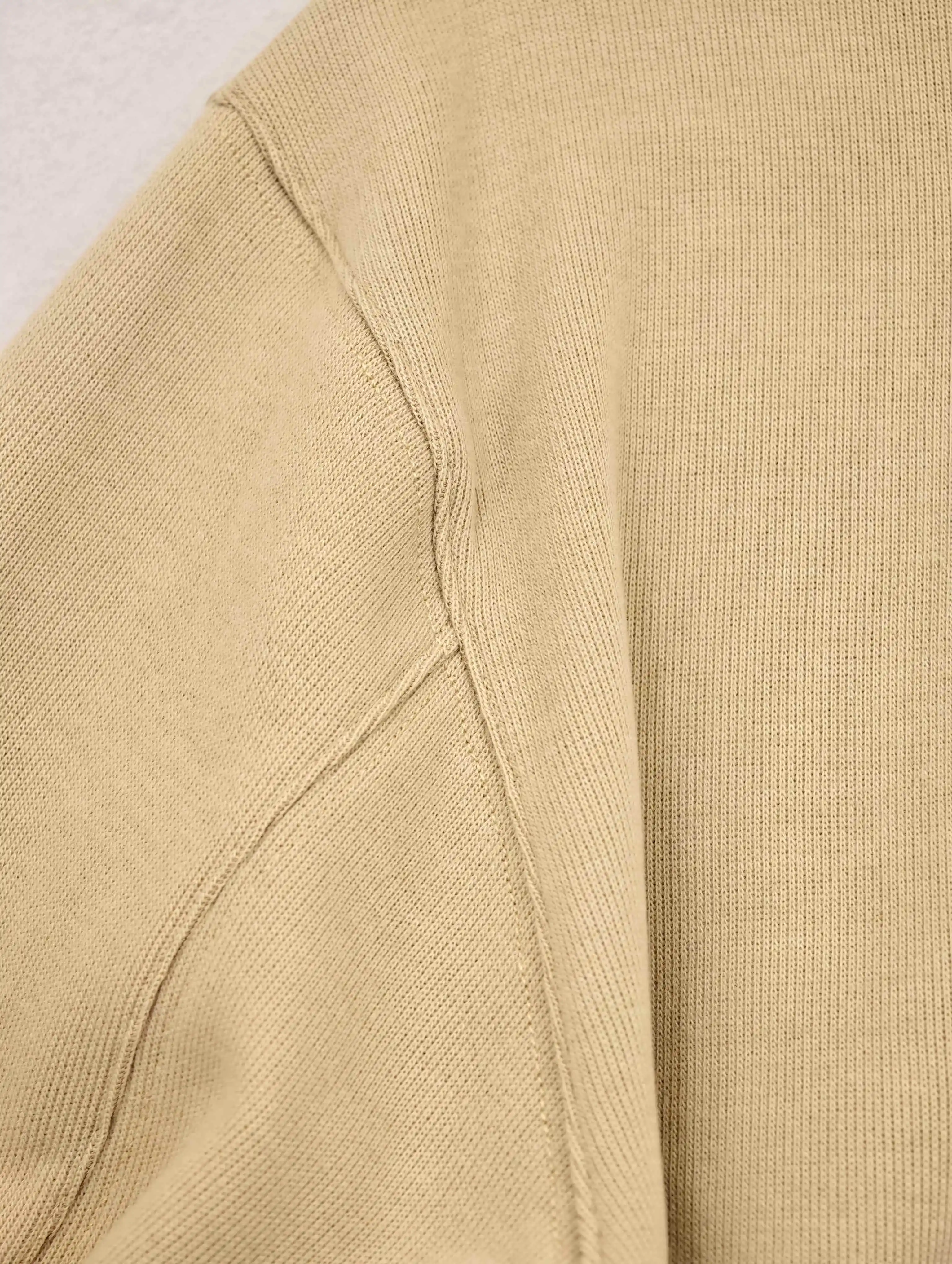 Dropped shoulder and underarm seam stitching close-up