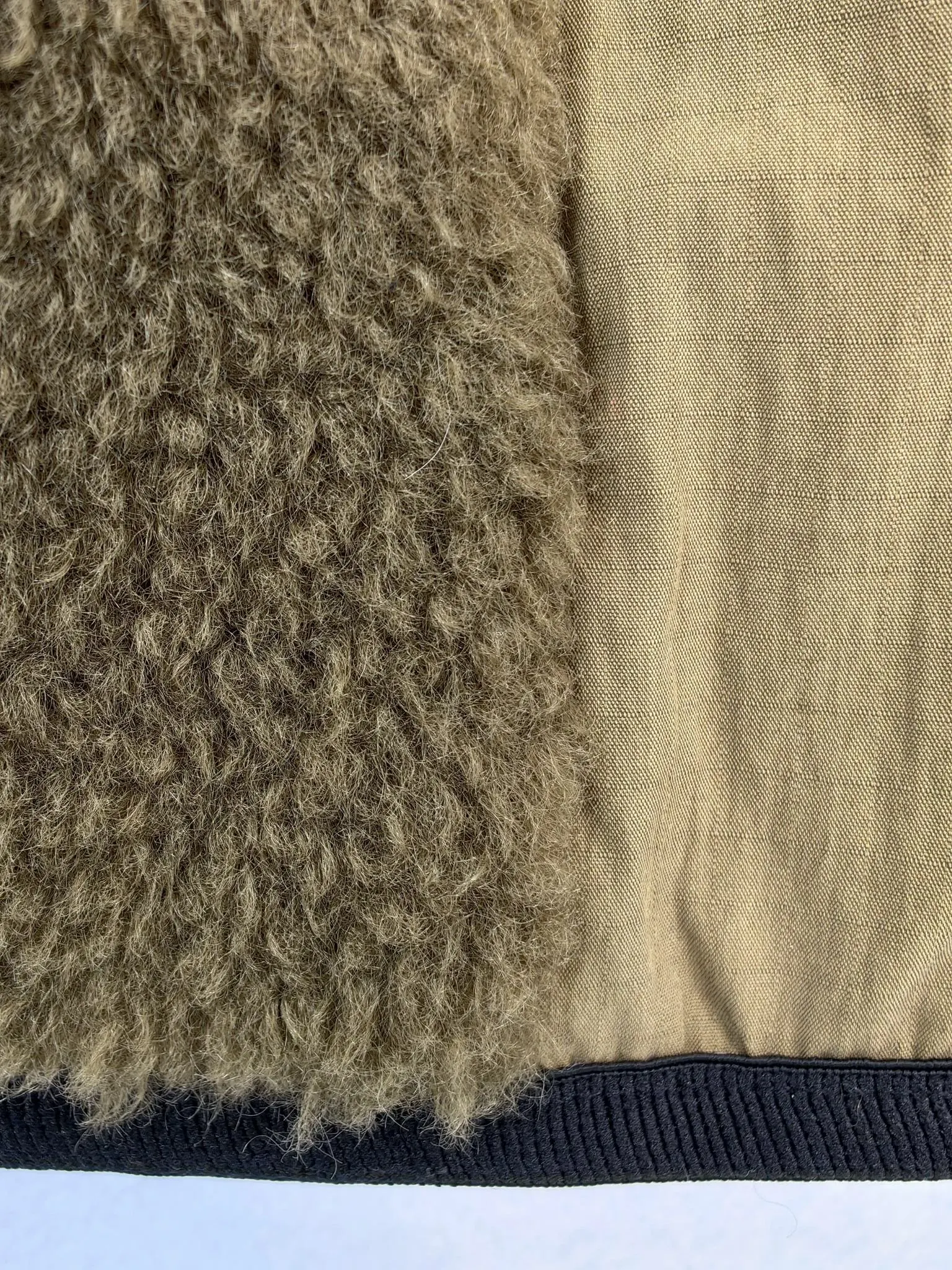 Sherpa pile, polyester lining and bound hem construction