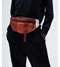 With multiple compartments and adjustable straps, our waist bags offer ample storage space for all your essentials, while still allowing for hands-free carrying. Our leather waist bags come in a range of stylish designs and colors that will complement you